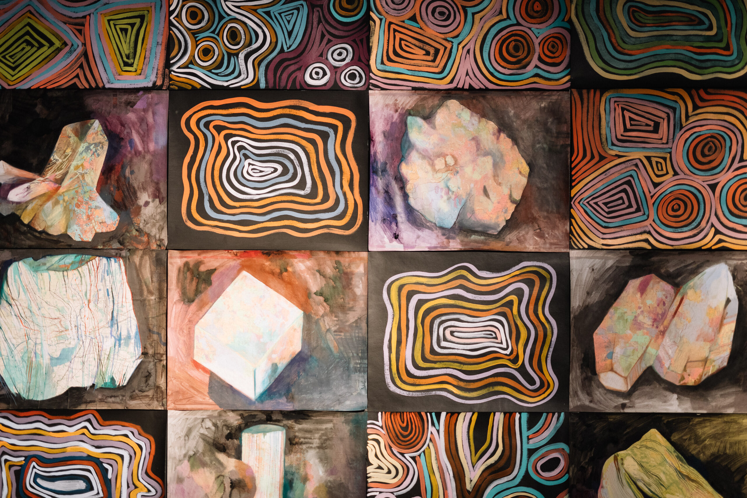 A grid of small paintings of minerals by Laura Wills and Jackie Saunders.